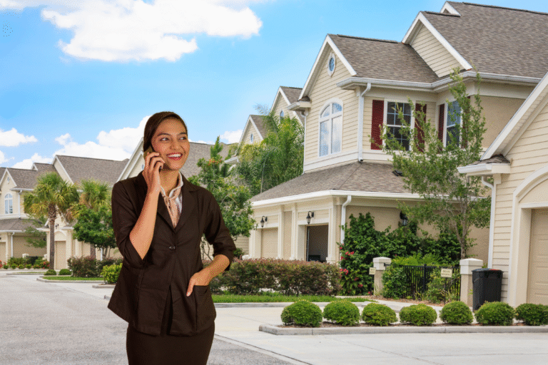 Femme souriante au téléphone devant des maisons.