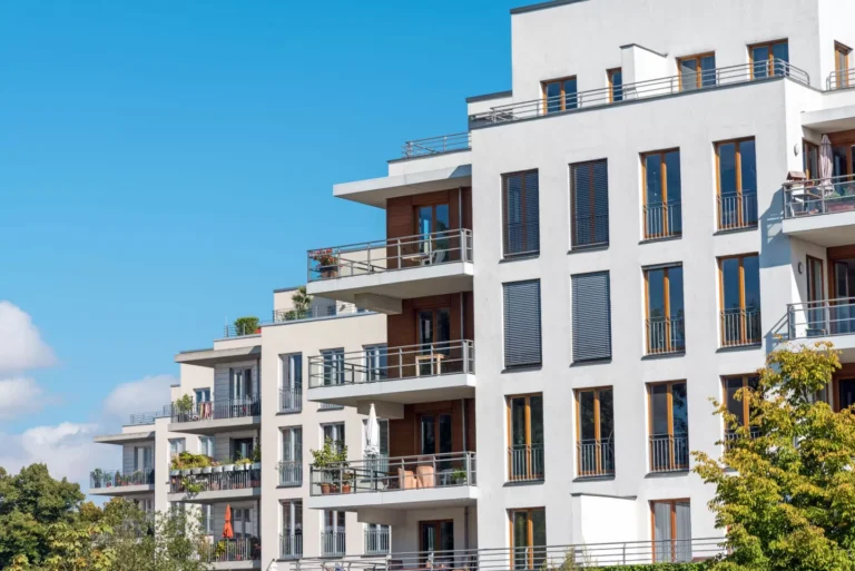 Bâtiments modernes avec balcons et verdure environnante.