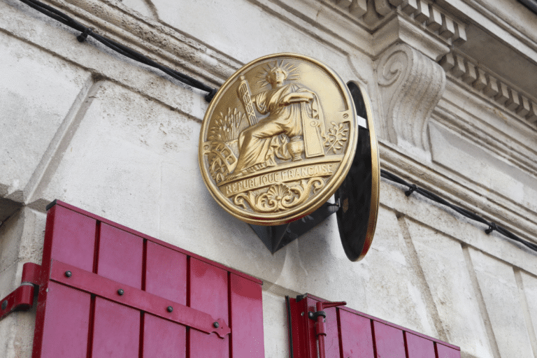 Emblème doré de la République française sur mur.