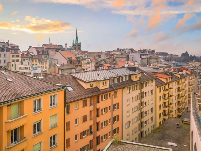 Vue de la ville avec bâtiments colorés et église.